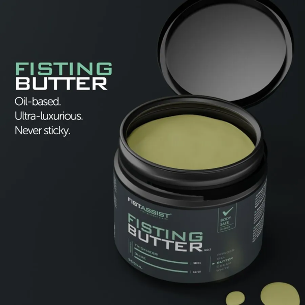 High-angle shot of an open 500 ml dark gray tub of FistAssist Fisting Butter No. 3 with the lid open, showing the smooth pale-green butter inside next to mint-green text reading "Oil-based. Ultra-luxurious. Never sticky."