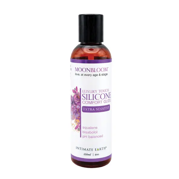 Front studio view of the 120 ml (4 fl oz) amber bottle of Intimate Earth Moon Bloom luxury touch silicone comfort glide for extra sensitive skin, highlighting squalene and bisabolol ingredients.