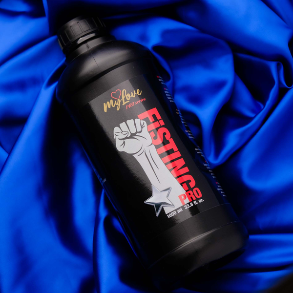 The MyLove Fisting Pro Gel 1000 ml bottle rests at an angle on a rich, draped royal blue satin cloth background.