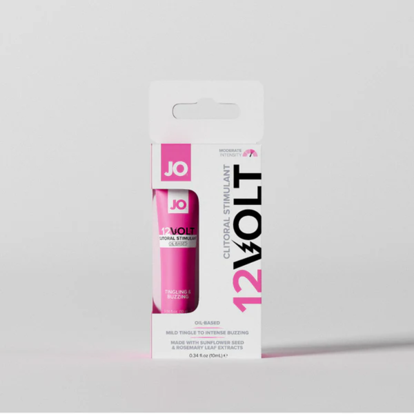 Front view of the boxed System JO 12VOLT Clitoral Stimulant, standing centered against a light grey background with soft shadows. The package specifies it is an oil-based formula containing 10 ml of product.
